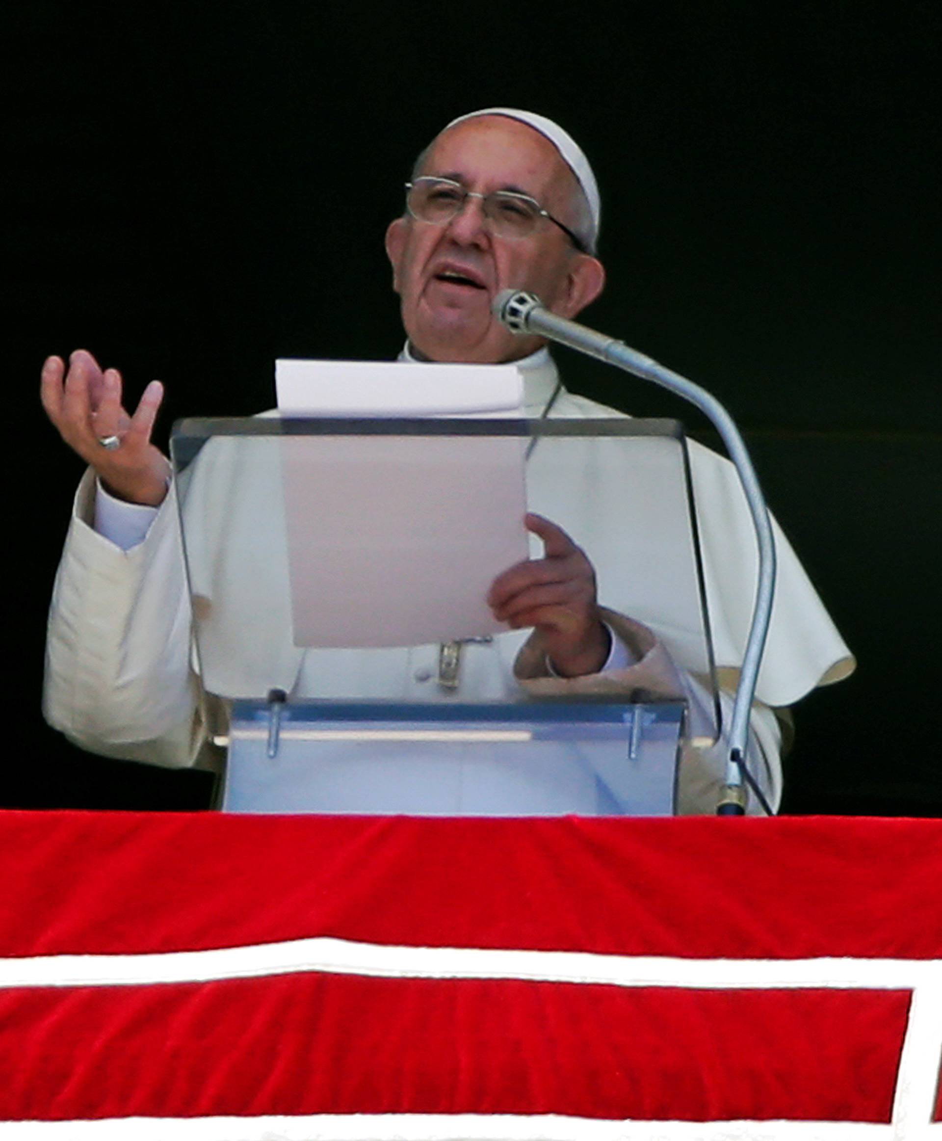 Pope Francis talks as he leads the Angelus prayer in Saint Peter's Square at the Vatican 