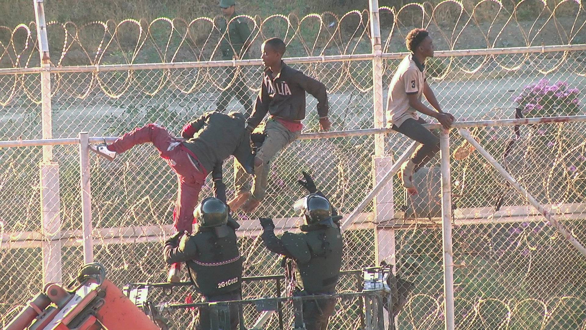 African migrants in this still image from video climb the border from Morocco to Spain's North African enclave of Ceuta