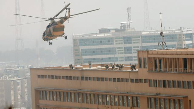 Afghan National Army (ANA) soldiers descend from helicopter on a roof of a military hospital during gunfire and blast in Kabul, Afghanistan