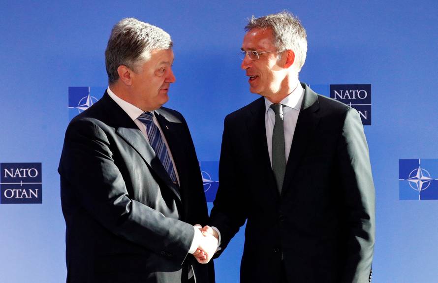 Ukrainian President Poroshenko poses with NATO's Secretary General Stoltenberg in Brussels