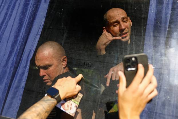 Freed Ukrainian POWs return after a swap in an undisclosed location in Ukraine