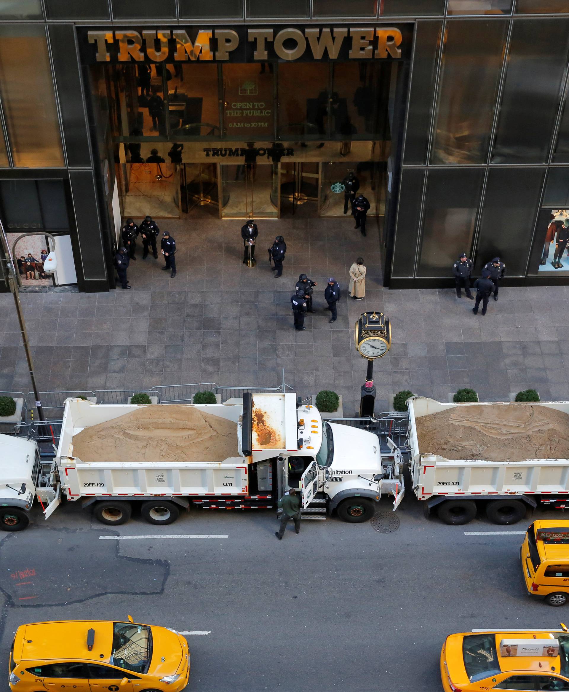 Sanitation trucks filled with sand act as barricades along Fifth Avenue outside Republican presidential nominee Donald Trump's Trump Tower in Manhattan, New York, U.S.