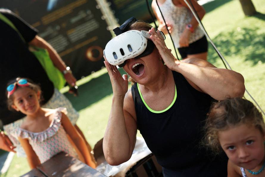 People attend an eclipse watch party on the day of a total solar eclipse in Buitrago del Lozoya
