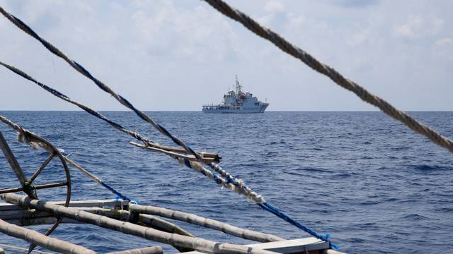 FILE PHOTO: A China Coast Guard ship is seen from a Philippine fishing boat at the disputed Scarborough Shoal