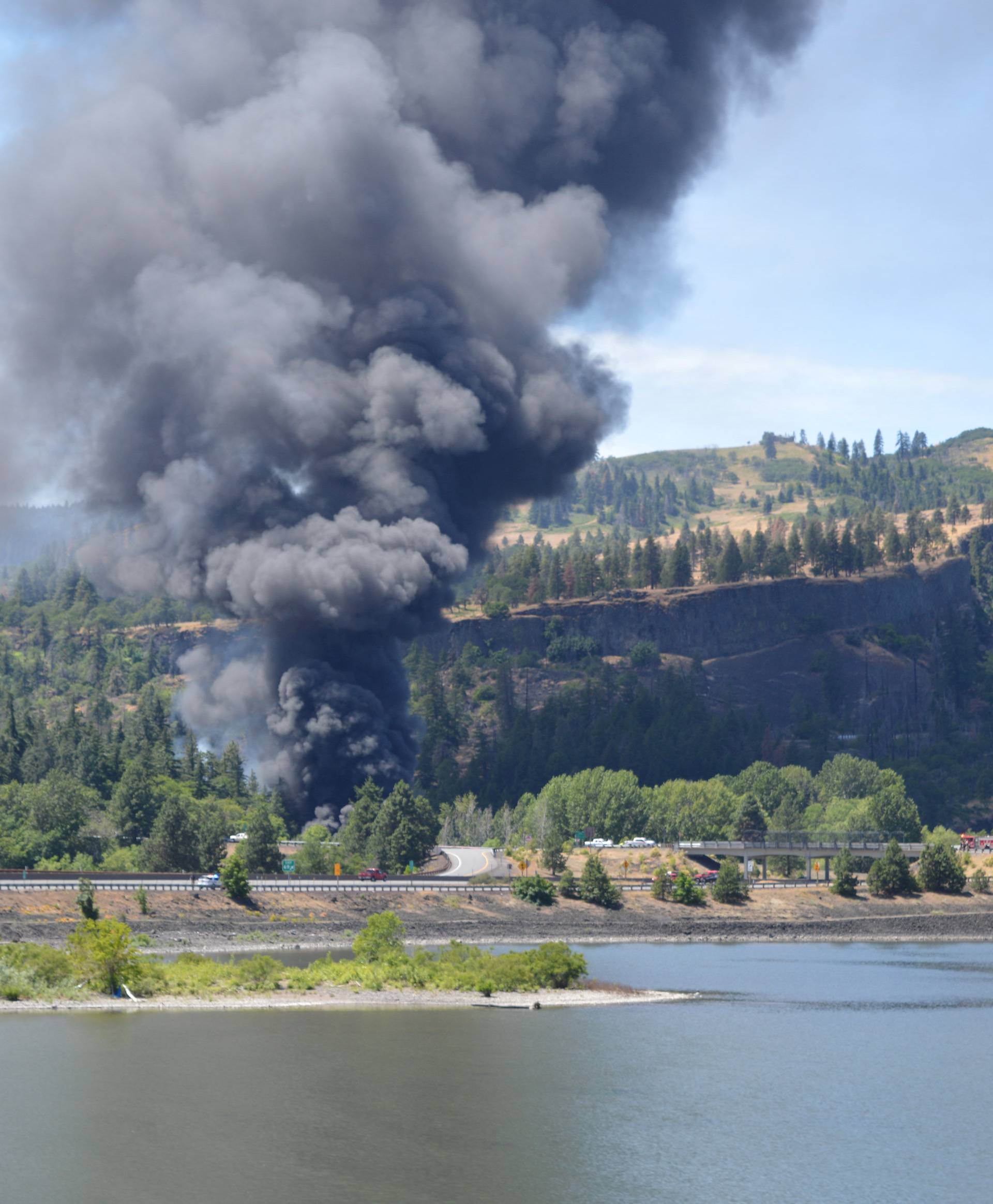 Handout photo of smoke billowing from a derailed oil train near Mosier, Oregon