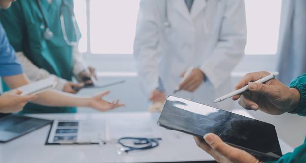 Multiracial medical team having a meeting with doctors in white 