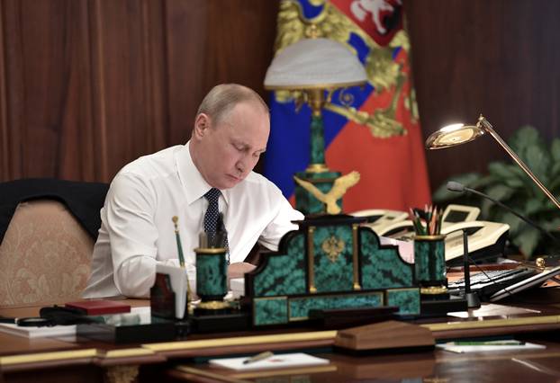 Russian President Putin works in his cabinet before an inauguration ceremony at the Kremlin in Moscow