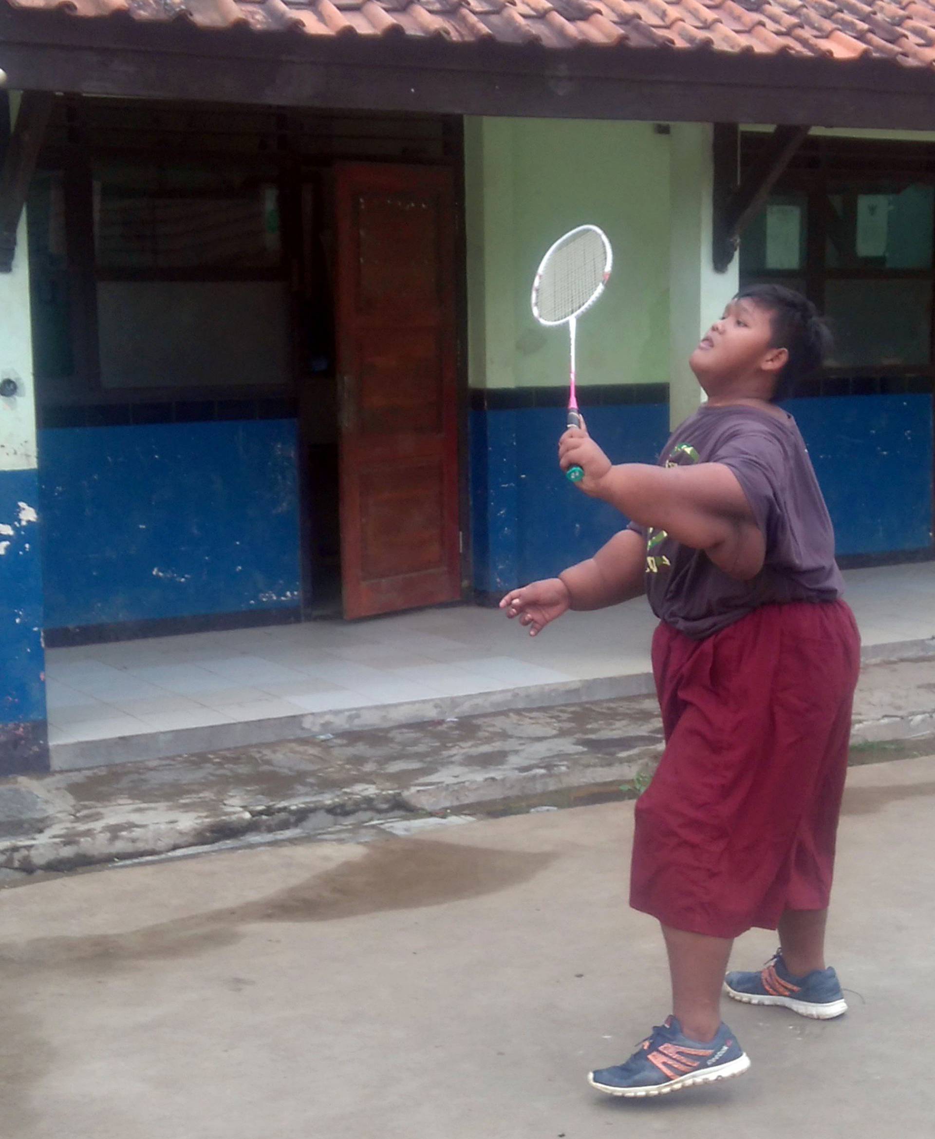 OBESE BOY PLAYS BADMINTON