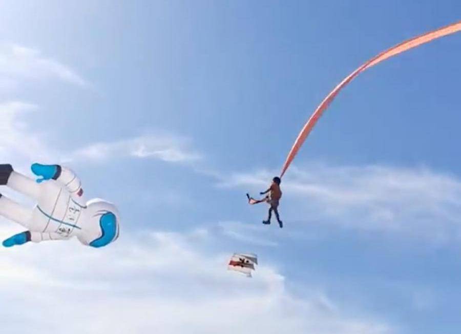 A child is pulled up in the air by a kite at an International Kite Flying Festival, in Hsinchu