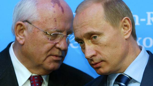 FILE PHOTO: Russian President Putin listens to former President of the Soviet Union Gorbachev during news conference in Schleswig