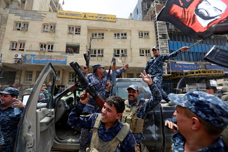 Iraqi Federal Police celebrate in the Old City of Mosul