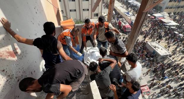 Palestinians inspect the site of Israeli strikes on Nasser Hospital where Reuters contractor was killed, in Khan Younis