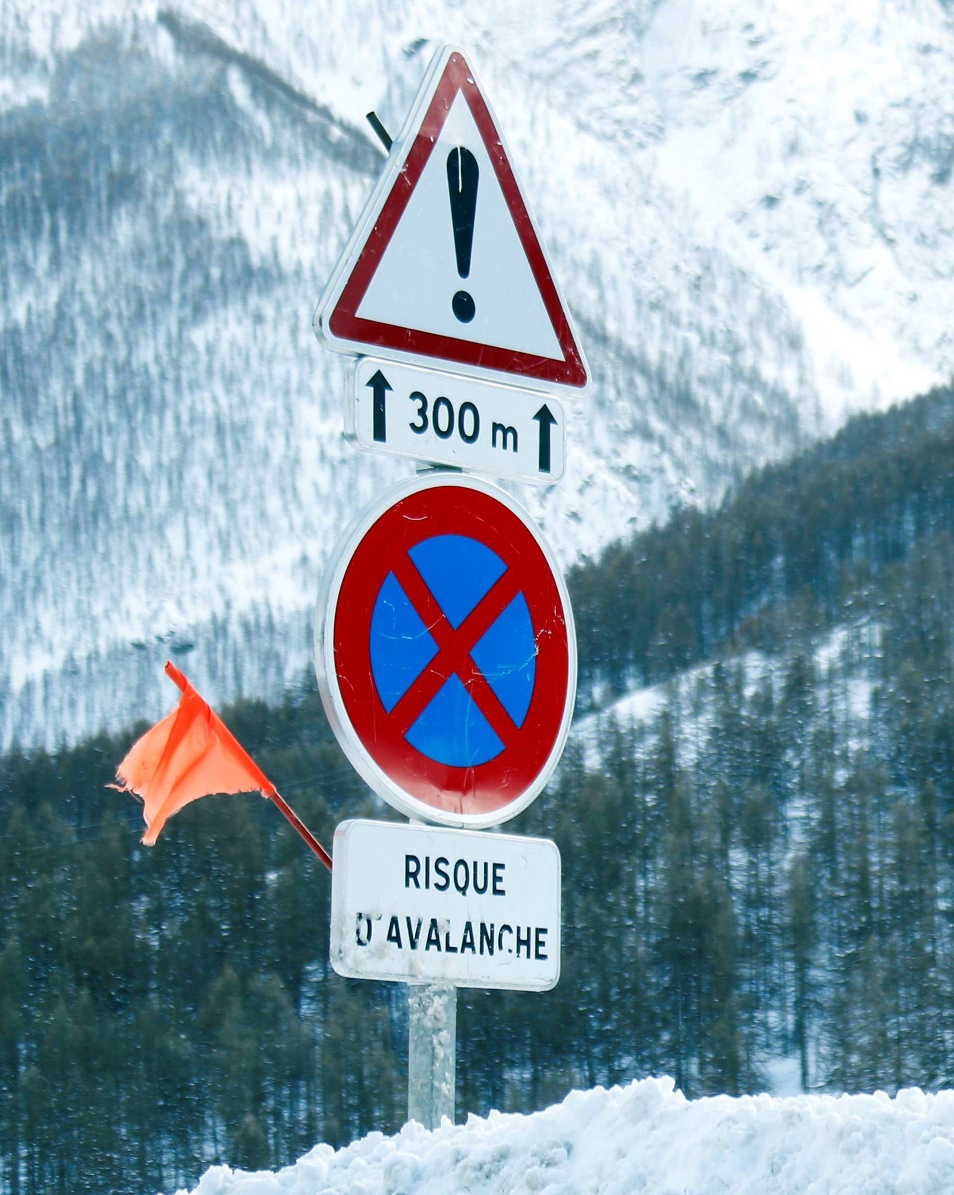 Road signs are pictured on a snow-covered road in Saint-Pancrace as winter weather bringing snow and freezing temperatures continues in France