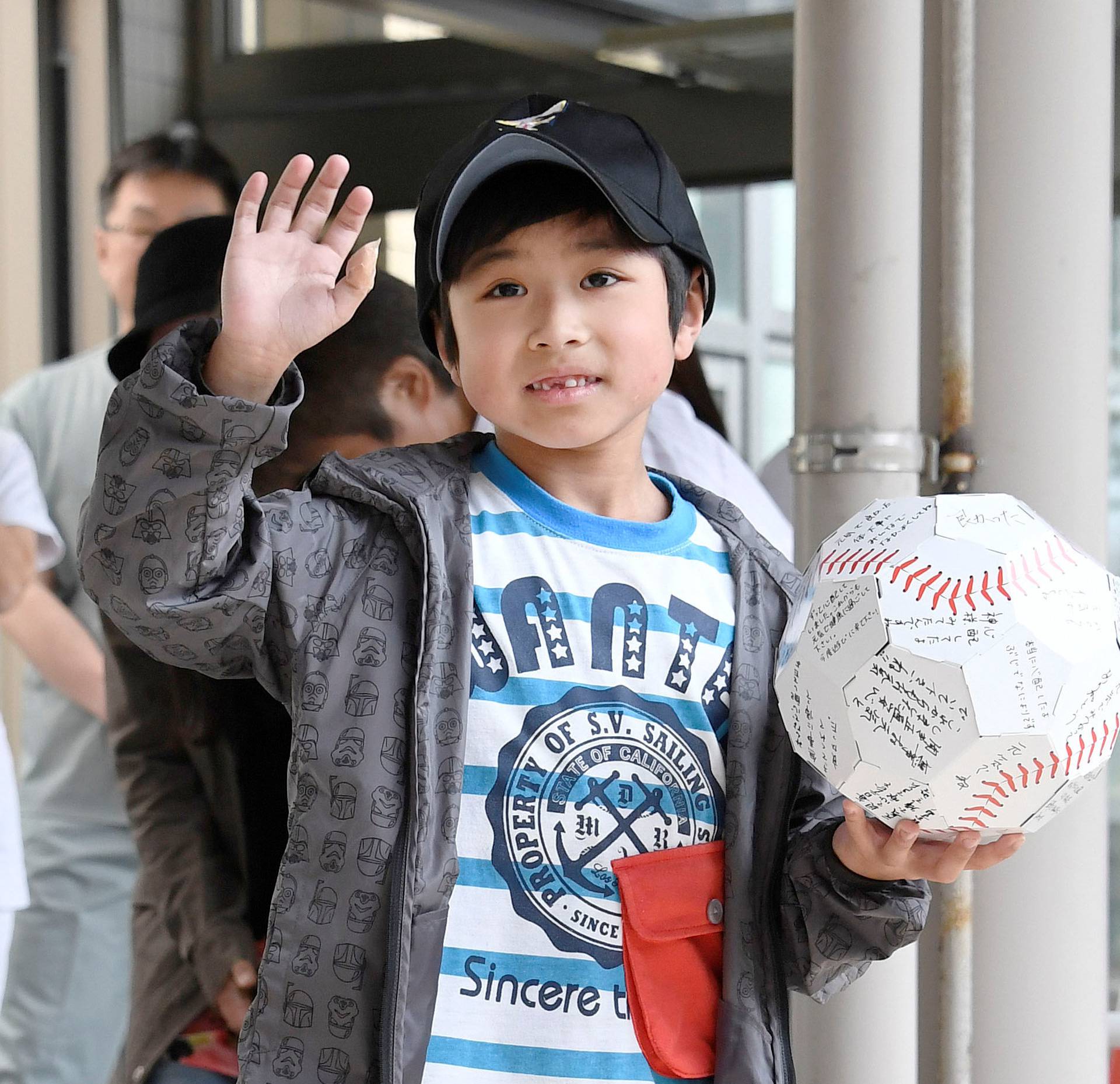 Yamato Tanooka, who was found by authorities in the woods nearly a week after his parents abandoned him for disciplinary reasons, waves as he leaves a hospital in Hakodate