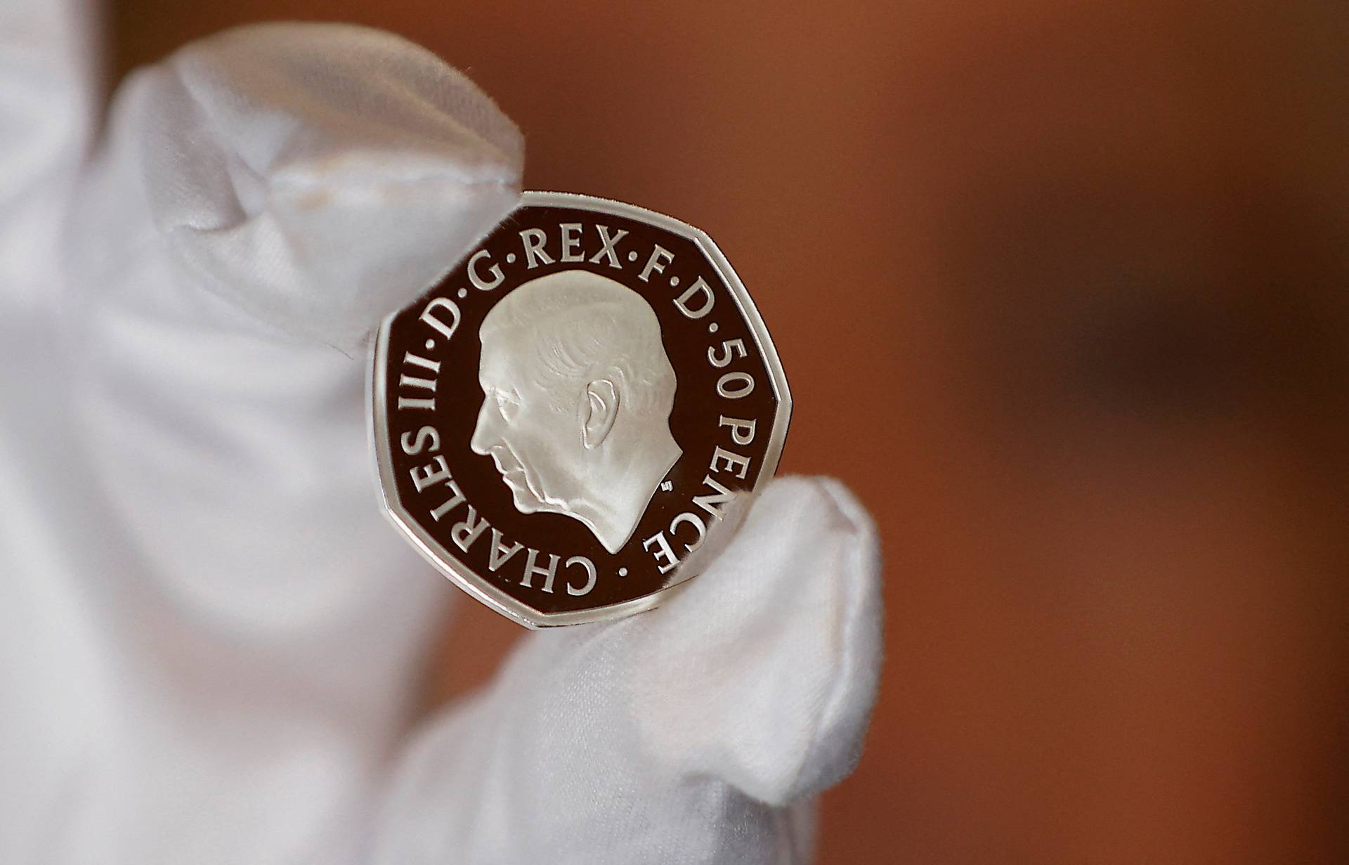 The official coin effigy of Britain’s King Charles III is seen on a 50 pence coin, unveiled by The Royal Mint, in London