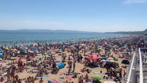 People enjoy the hot weather at the beach in Bournemouth