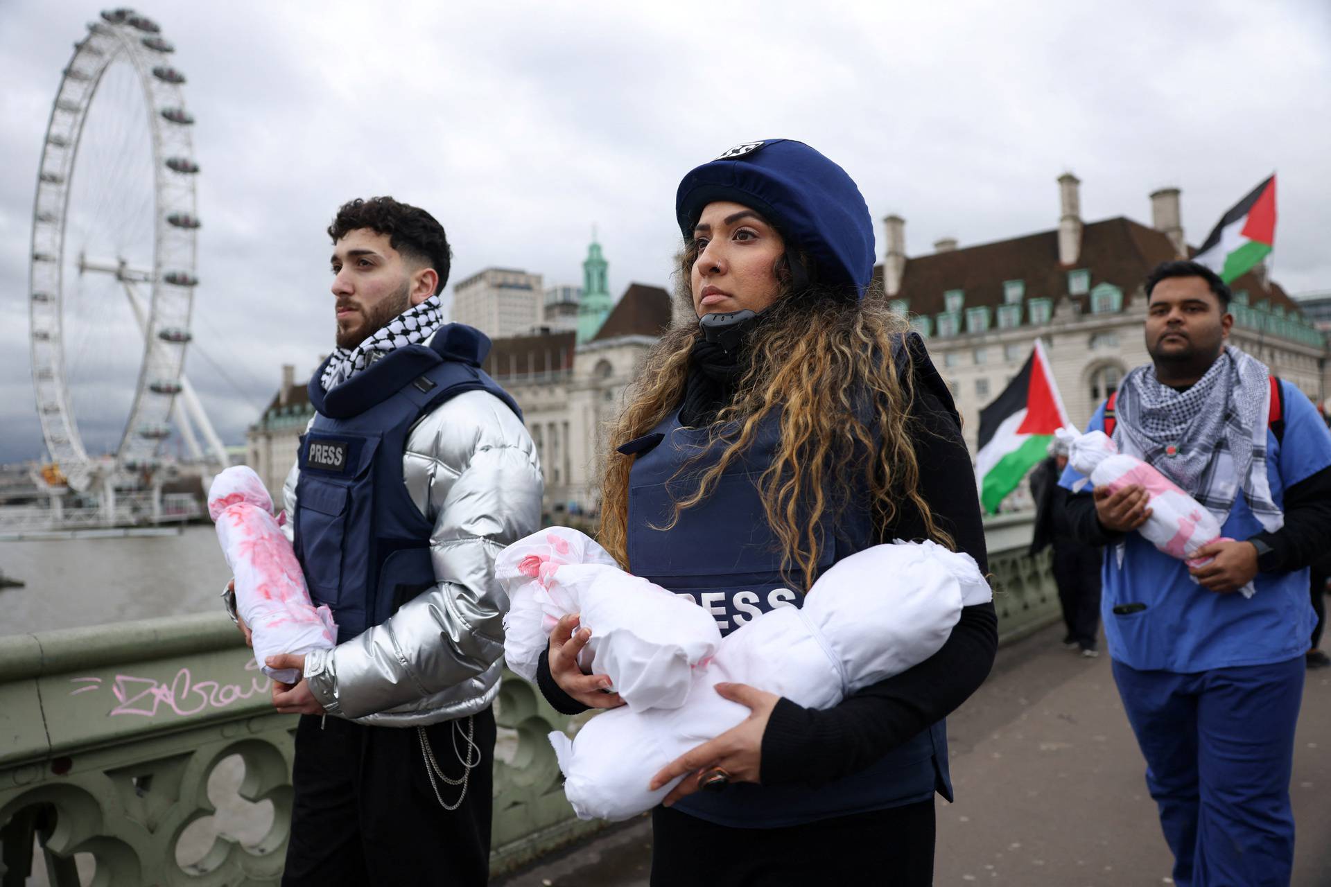 Health workers participate in a silent procession during a vigil for Gaza in London