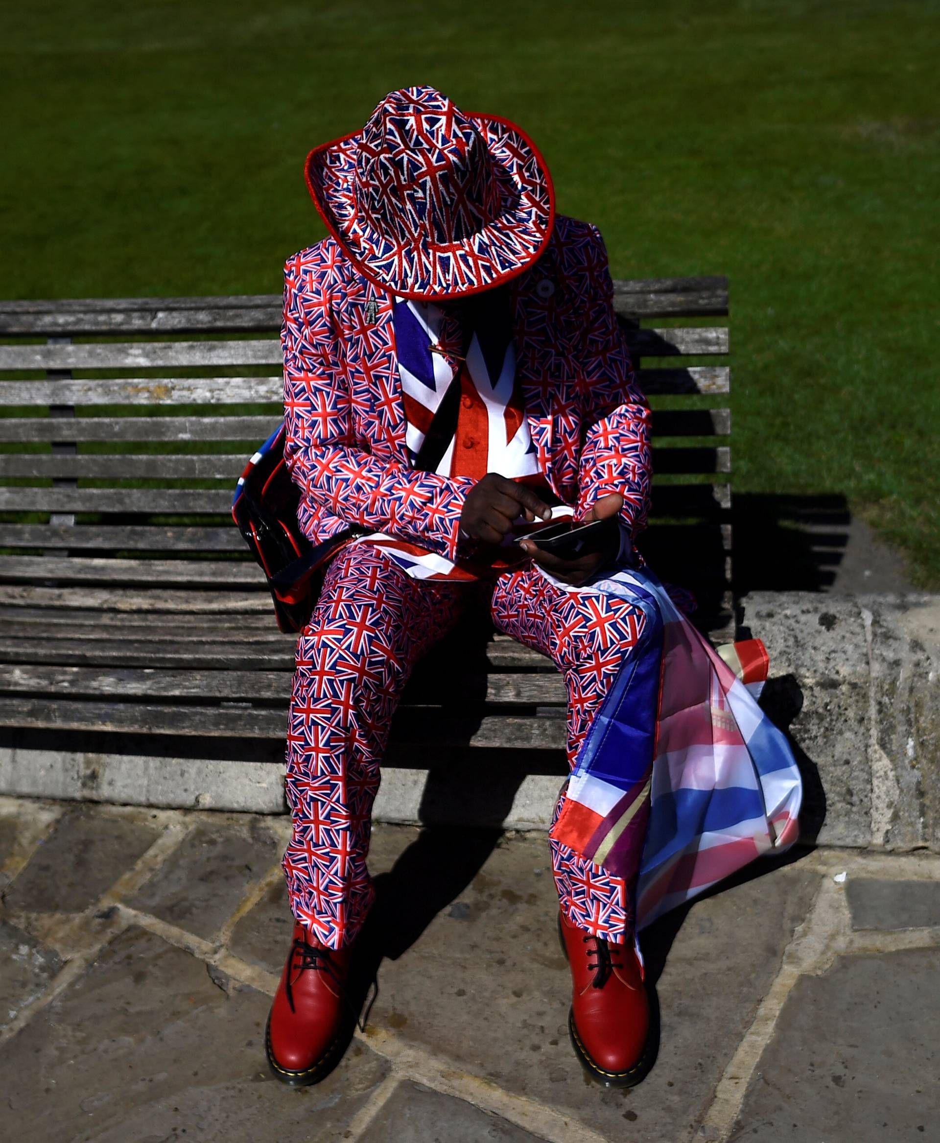 A man wears a Union flag themed suit outside Windsor Castle ahead of Britain's Prince Harry's wedding to Meghan Markle in Windsor