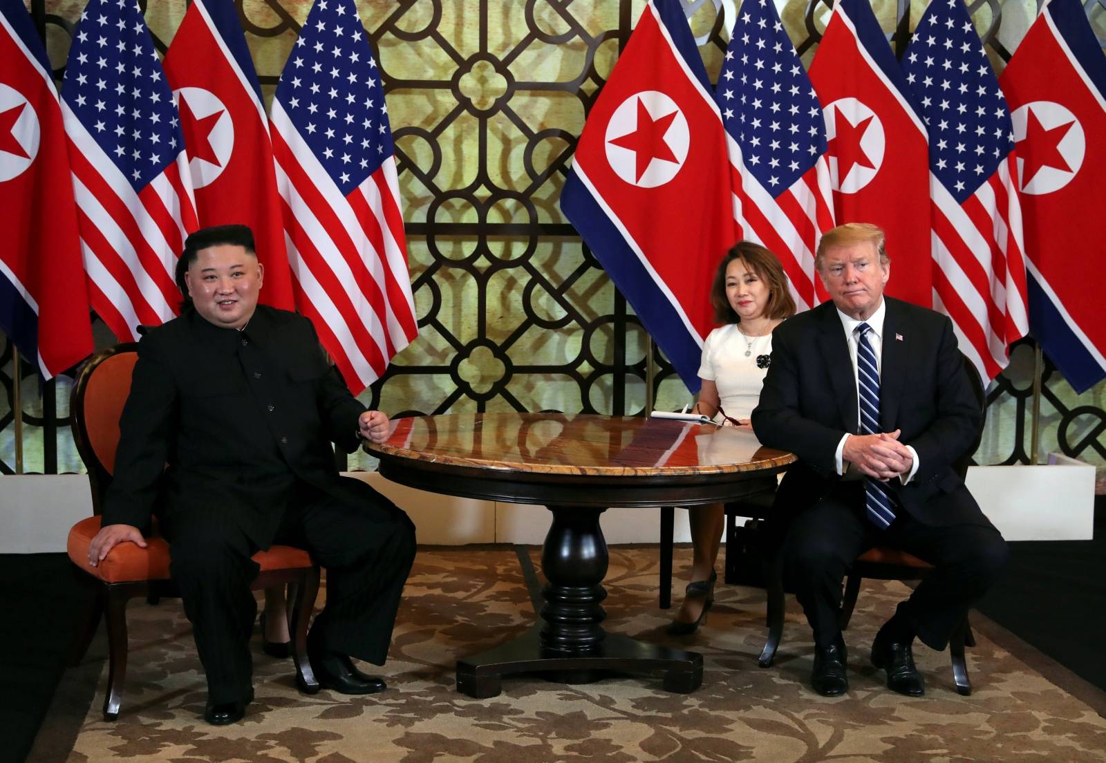 U.S. President Donald Trump and North Korean leader Kim Jong Un react during the one-on-one bilateral meeting at the second North Korea-U.S. summit in Hanoi