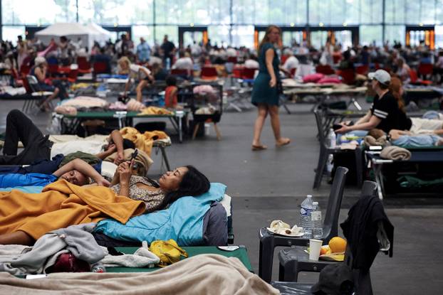 FILE PHOTO: Evacuated residents rest at the Bordeaux-Lac Exhibition Centre, in Bordeaux