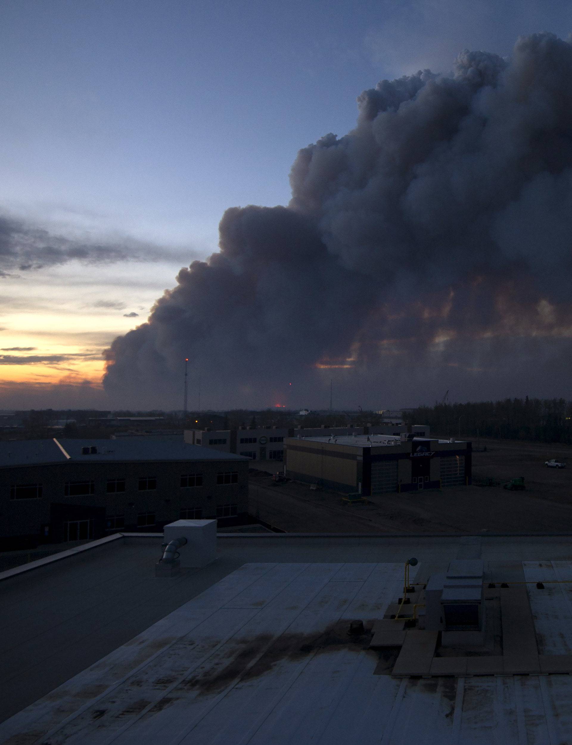 A massive plume of smoke, from a wildfire north of the city, stretches over Fort McMurray Alberta