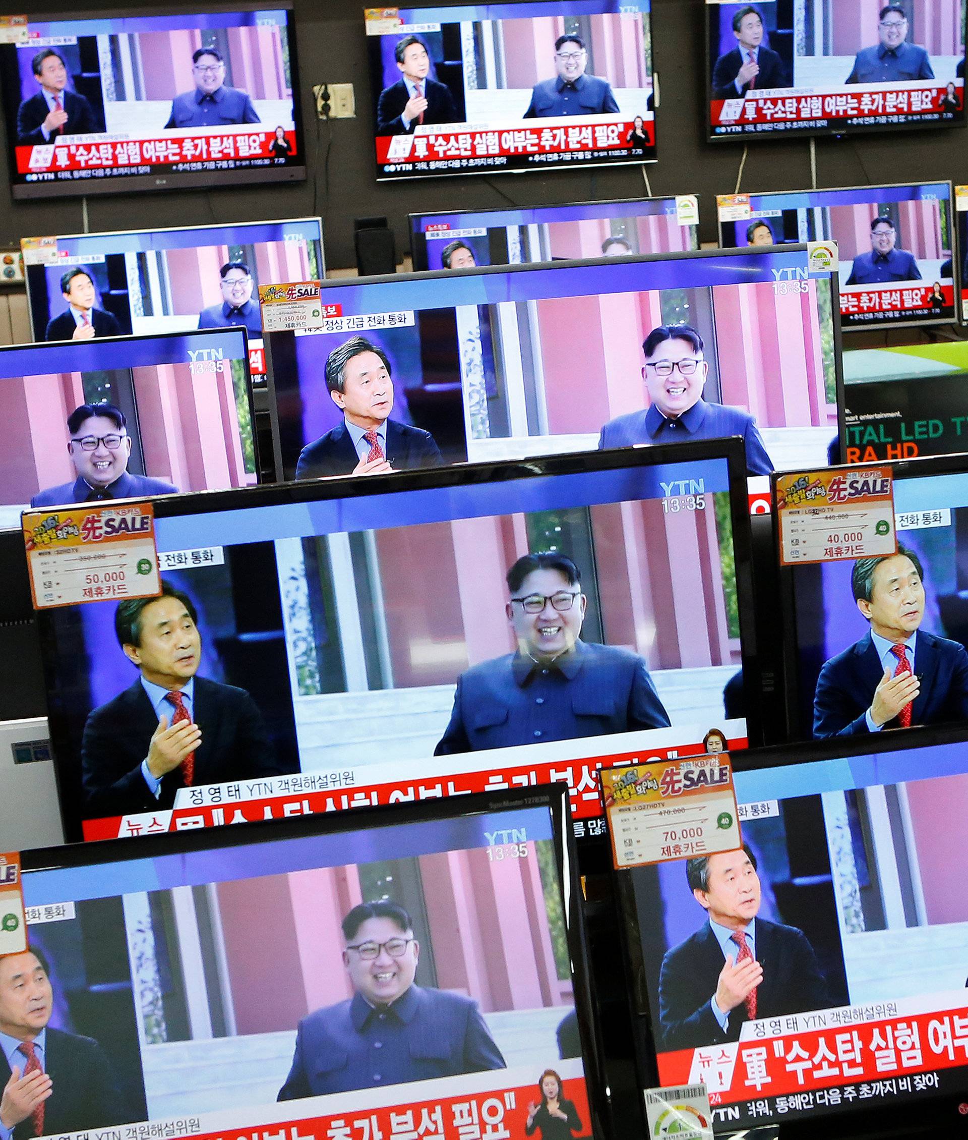 A sales assistant watches TV sets broadcasting a news report on North Korea's fifth nuclear test, in Seoul