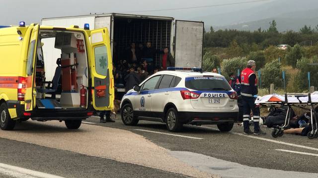 Migrants are seen inside a refrigerated truck found by police, after a check at a motorway near Xanthi