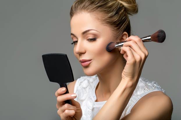 beautiful girl applying makeup