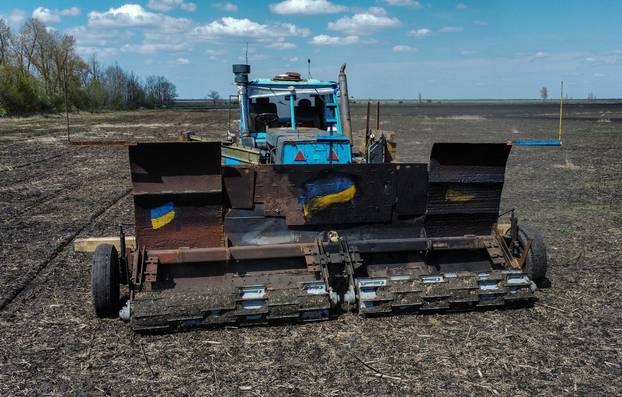 Remote controlled demining machine made of tractor and armoured plates from destroyed Russian military vehicles is seen in a field near the village of Hrakove