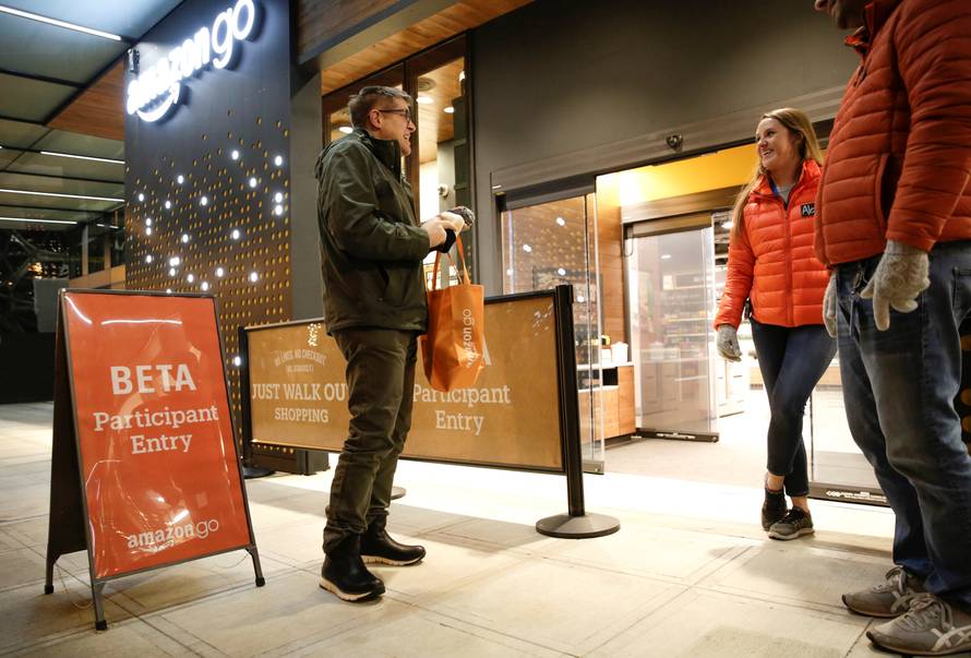 Amazon employees are pictured outside the Amazon Go store in Seattle Washington