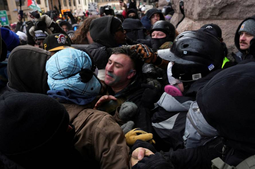 People attend the "March Against Minnesota Fraud" in Minneapolis