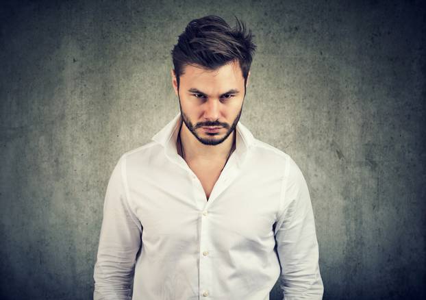 Offended young man looking at camera