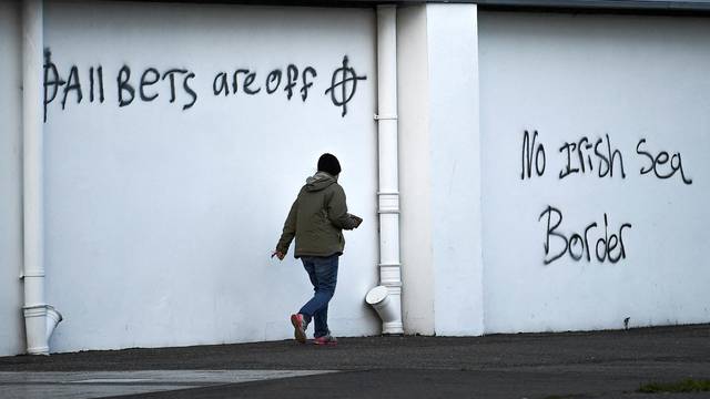 FILE PHOTO: Loyalist graffiti seen with messages against the Brexit border checks in relation to the Northern Ireland protocol at the harbour in Larne