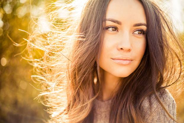 Beautiful lady in autumn landscape