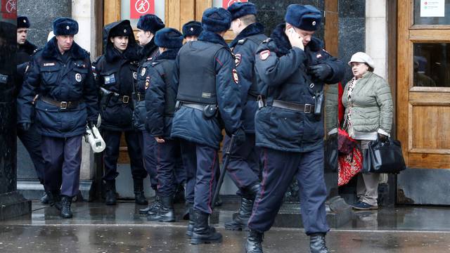 Police officers gather outside Ploschad Revolyutsii metro station in Moscow