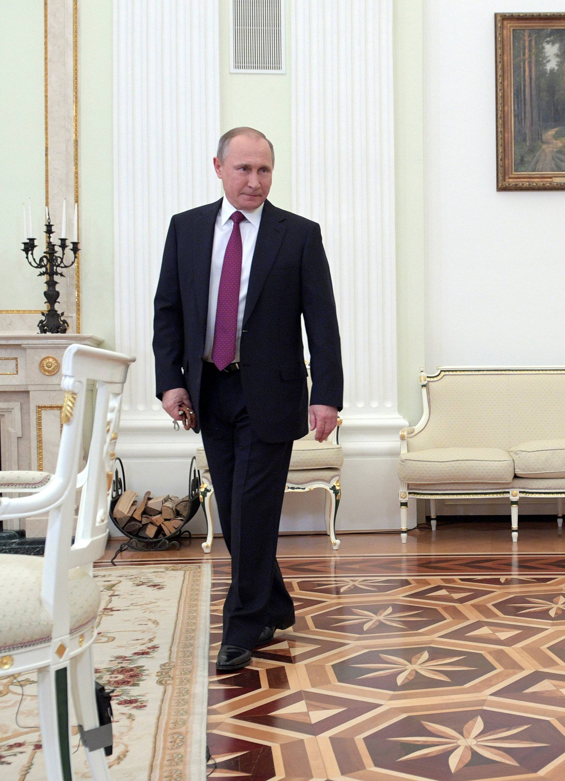 Russian President Putin enters a hall with his dog Yume before giving interview to Japanese Nippon Television and Yomiuri newspaper at Kremlin in Moscow