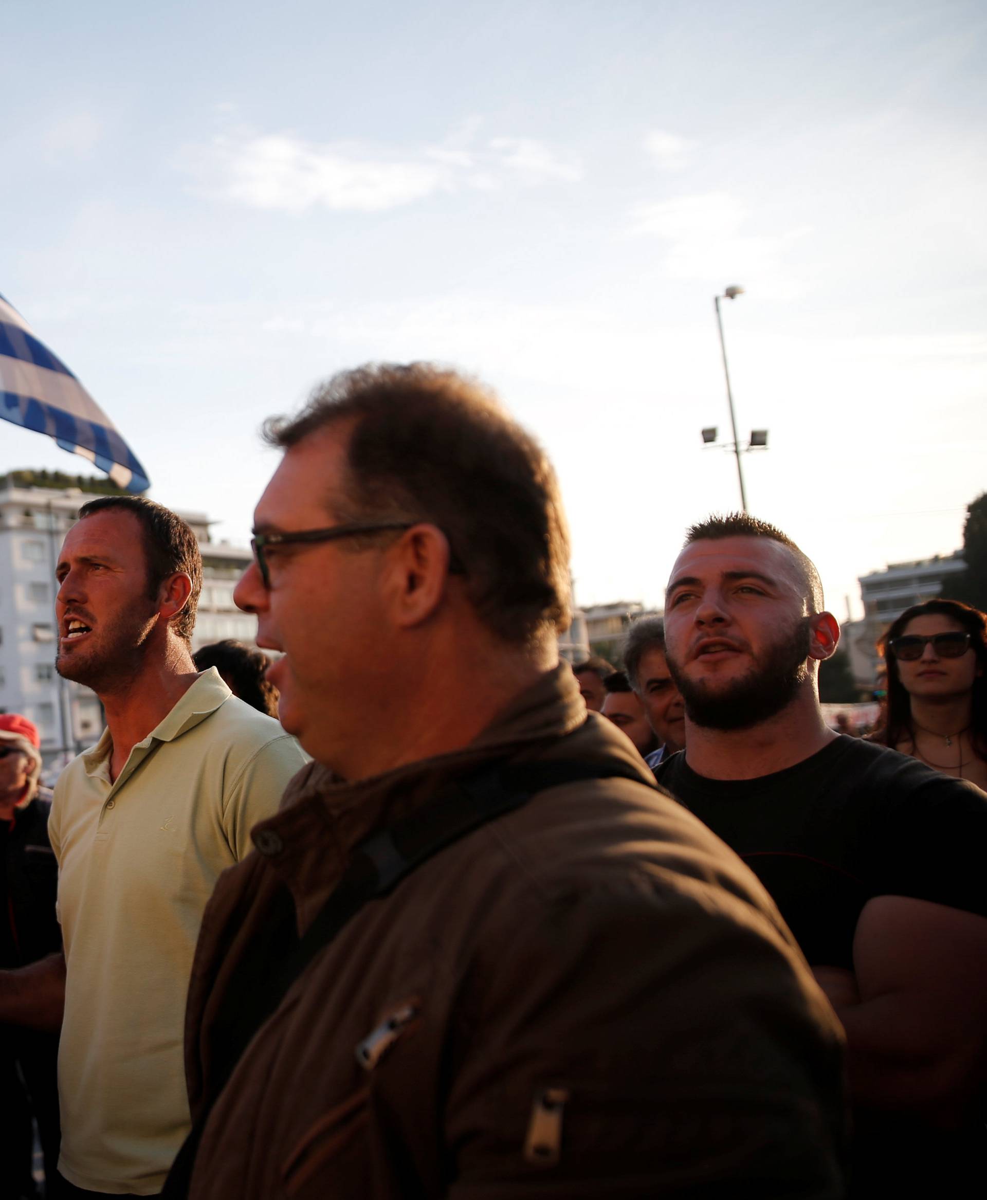 Protesters shout slogans during a demonstration outside the parliament building in central Athens