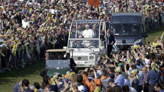 Pope Francis waves to the faithful from the popemobile as he arrives to celebrate Mass at Monza Park in Milan