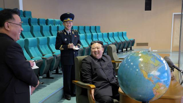 FILE PHOTO: North Korea's Kim inspects new spy satellite photos of 'target regions'