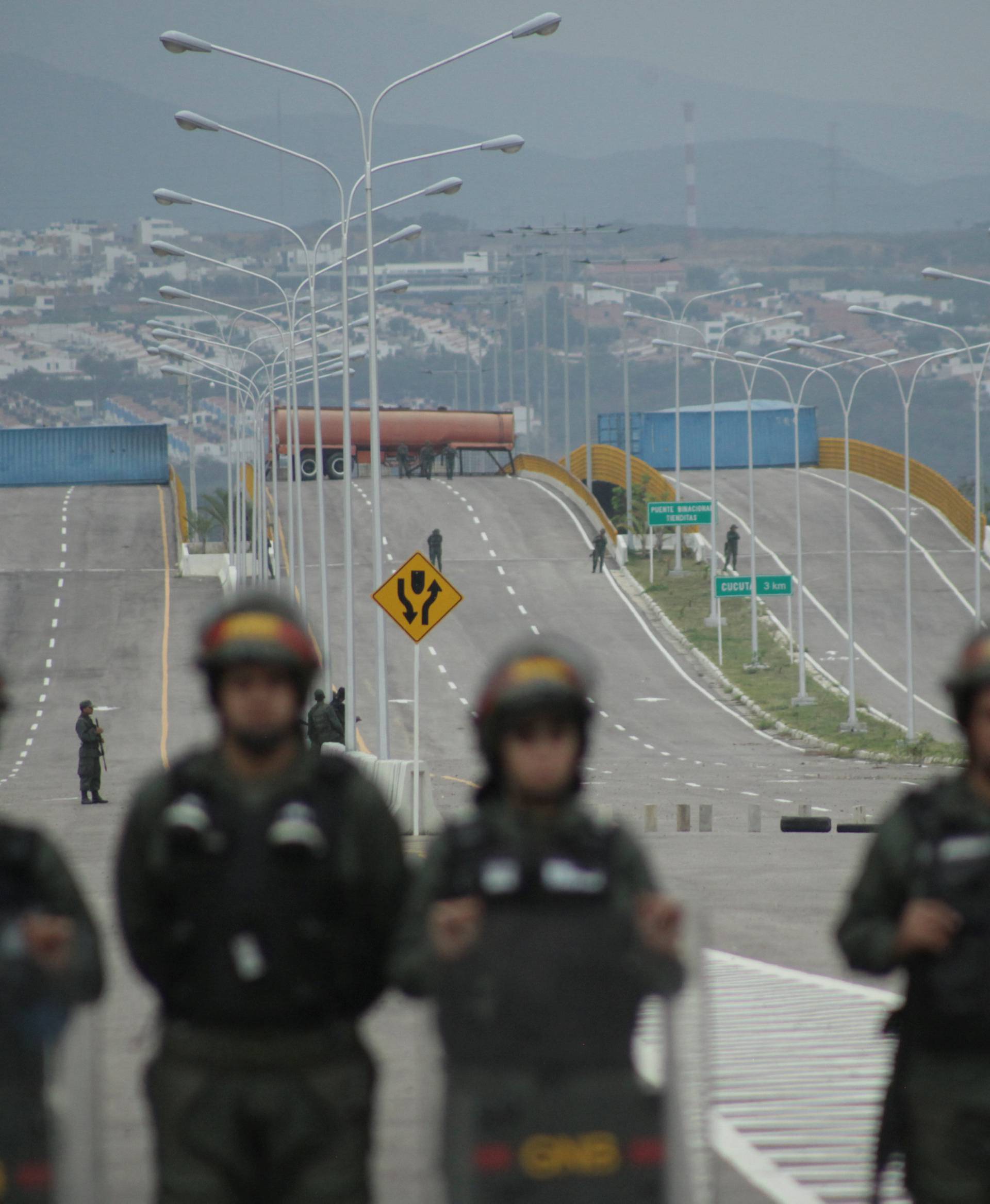 A fuel tank and cargo containers block the vehicular passage on Tienditas cross-border bridge between Colombia and Venezuela as seen from Tienditas