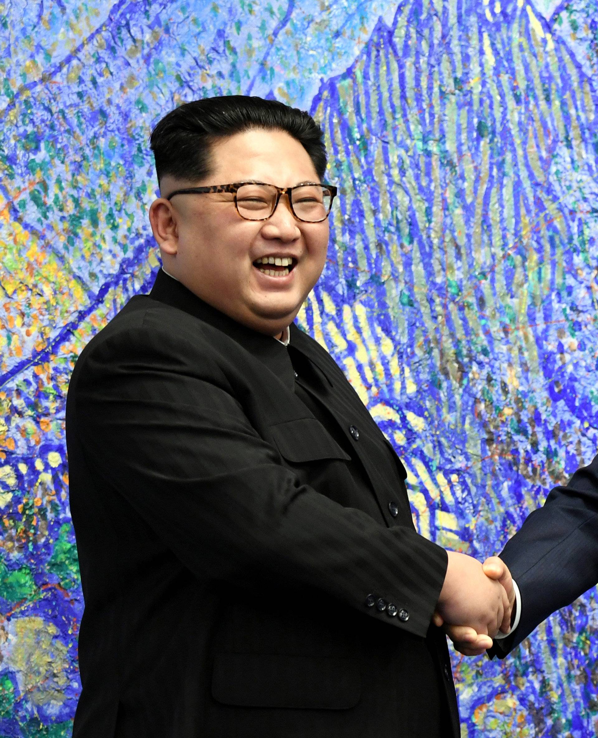 South Korean President Moon Jae-in shakes hands with North Korean leader Kim Jong Un during their meeting at the Peace House