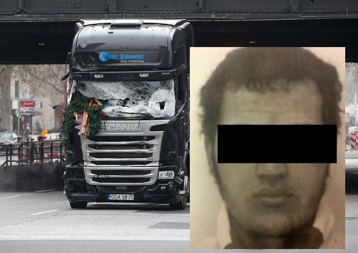 A policeman watches the truck which ploughed into a crowded Christmas market in the German capital last night in Berlin