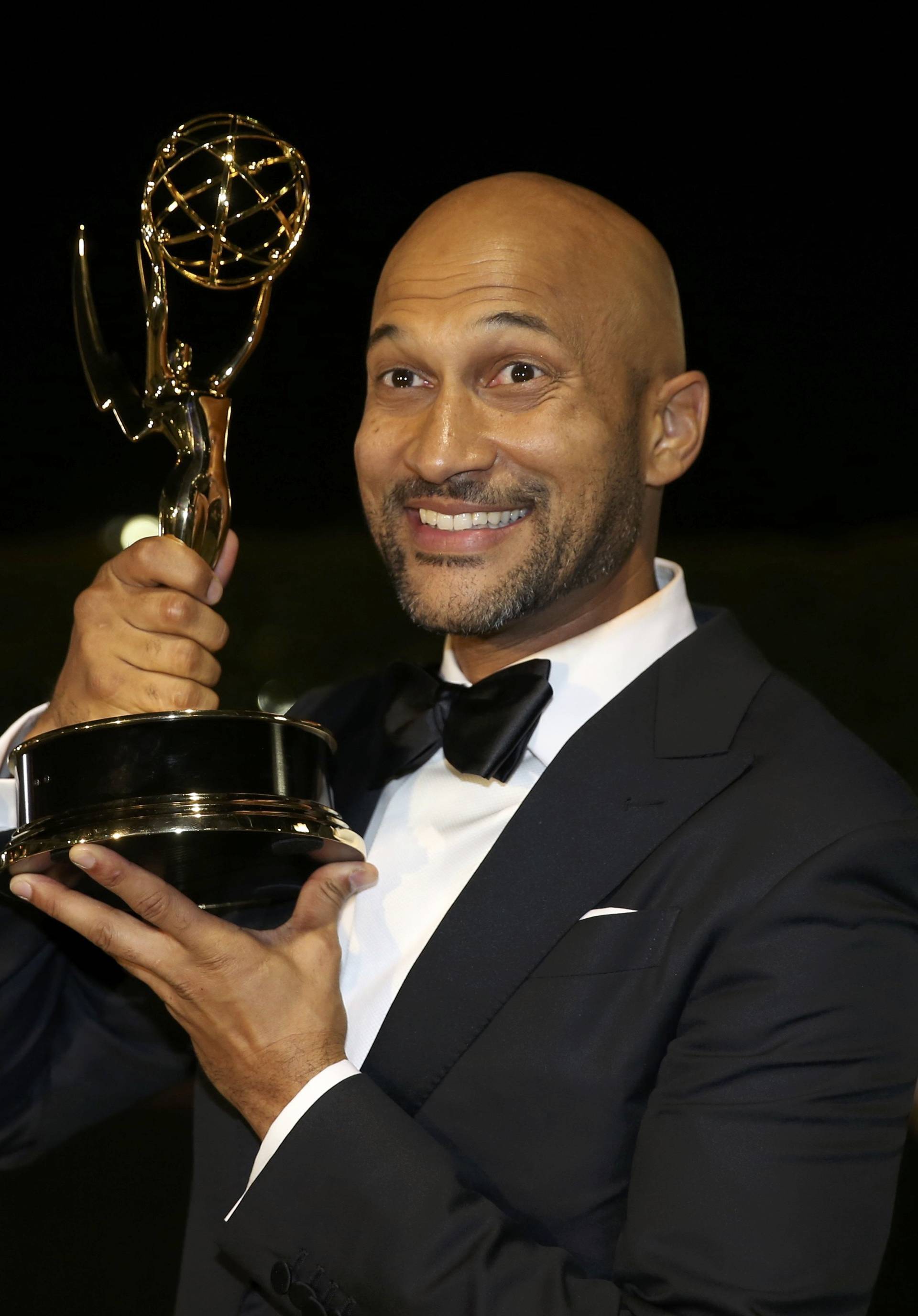 Keegan-Michael Key holds the award for Outstanding Variety Sketch Series as he arrives at the Governors Ball after the 68th Primetime Emmy Awards in Los Angeles