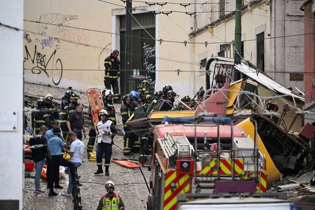 First responders work at the site of a funicular accident in Lisbon
