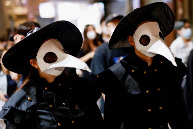 People wear costumes celebrating Halloween, in Hong Kong
