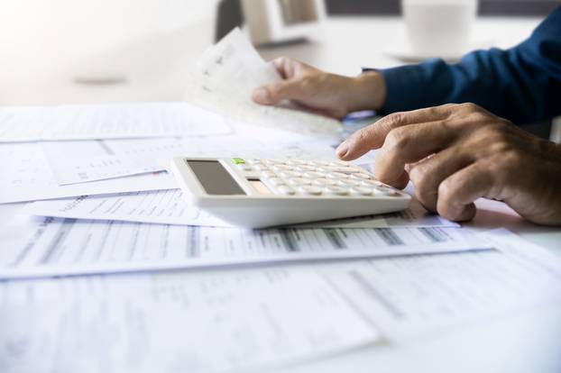 Close-up,Shot.,Asian,Men,Hand,Using,Calculator,To,Calculate,Expenses