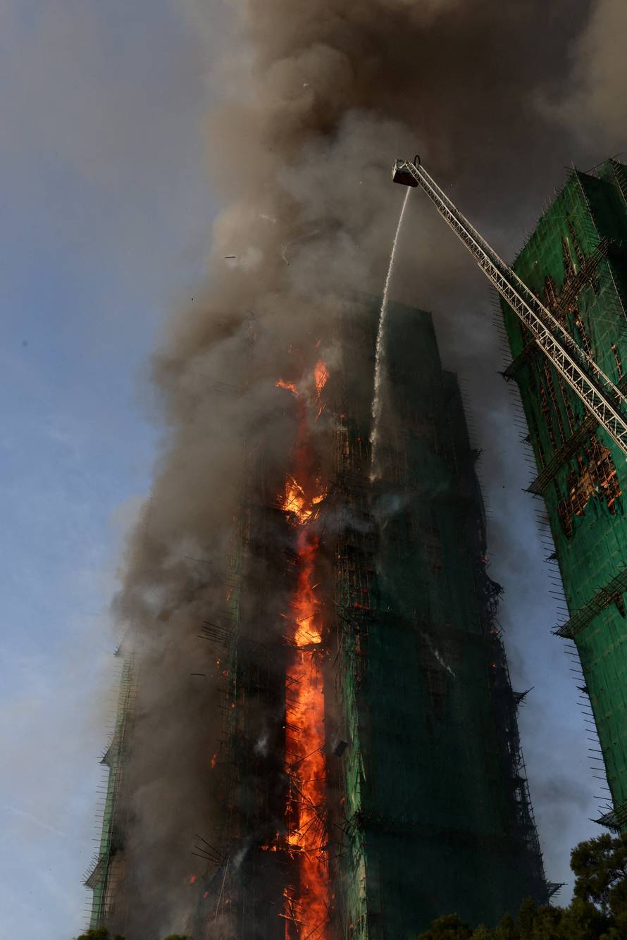 Flames engulf bamboo scaffolding across multiple buildings at Wang Fuk Court housing estate, in Tai Po