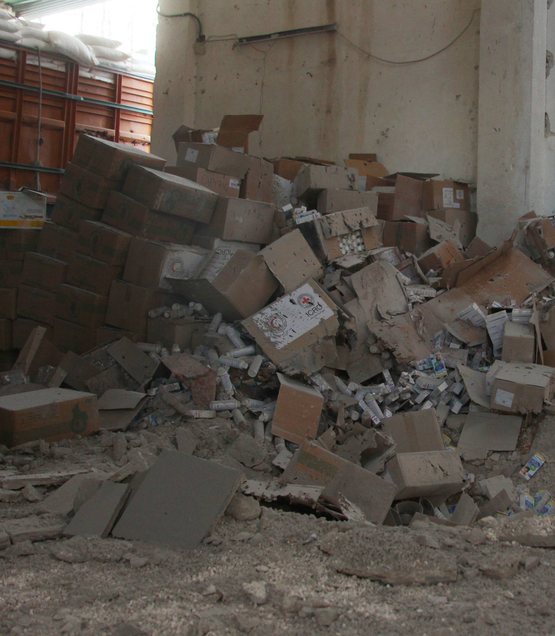 Damaged Red Cross and Red Crescent medical supplies lie inside a warehouse after an airstrike on the rebel held Urm al-Kubra town