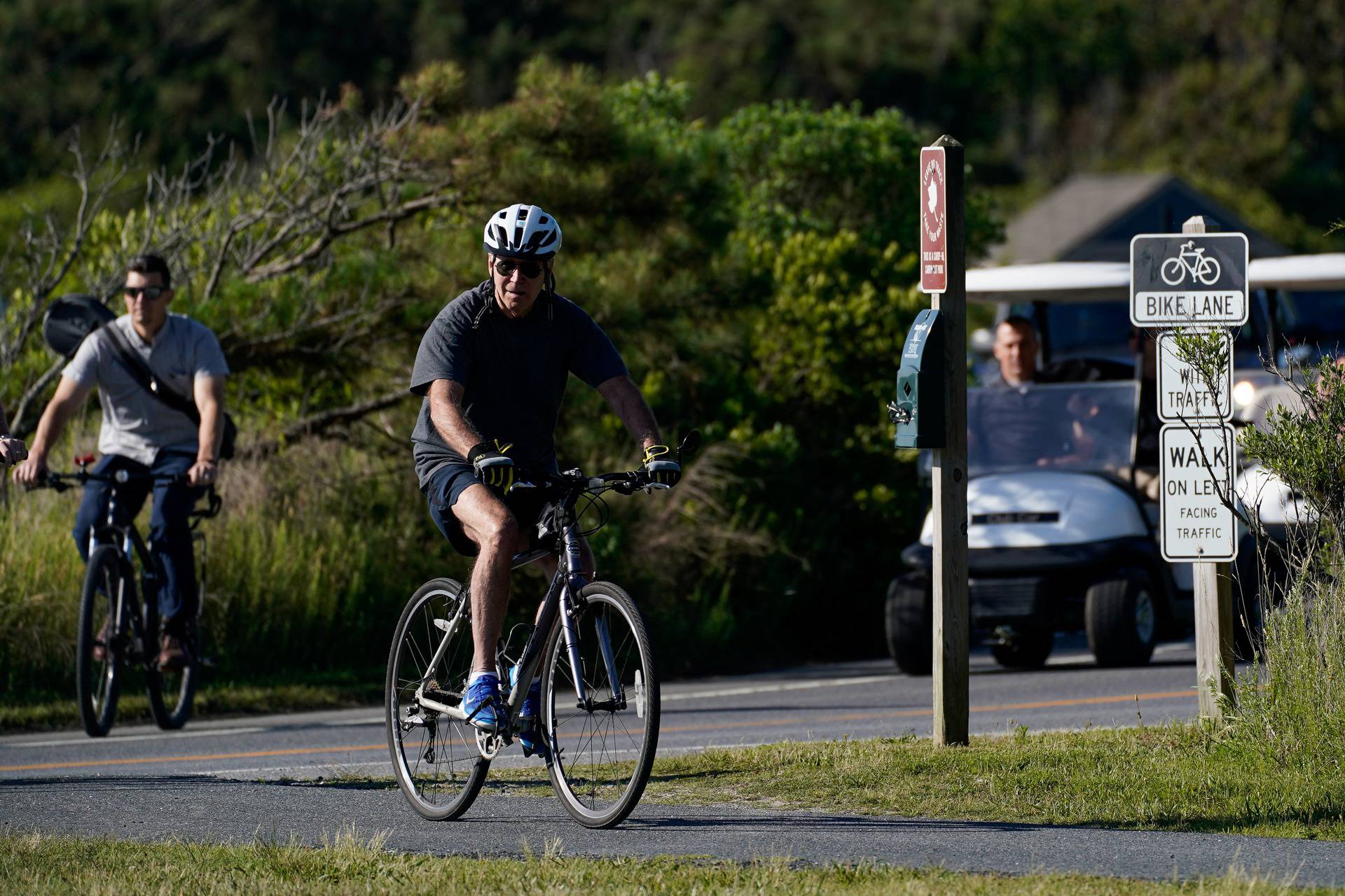 U.S. President Joe Biden rides a bike in Rehoboth Beach, Delaware