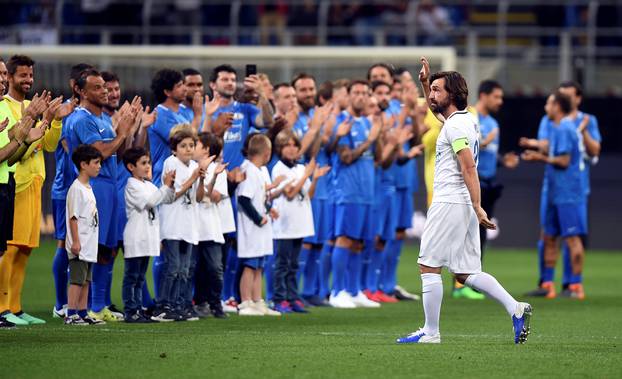 Former soccer player Andrea Pirlo waves supporters as he arrives for his farewell soccer match at the San Siro stadium